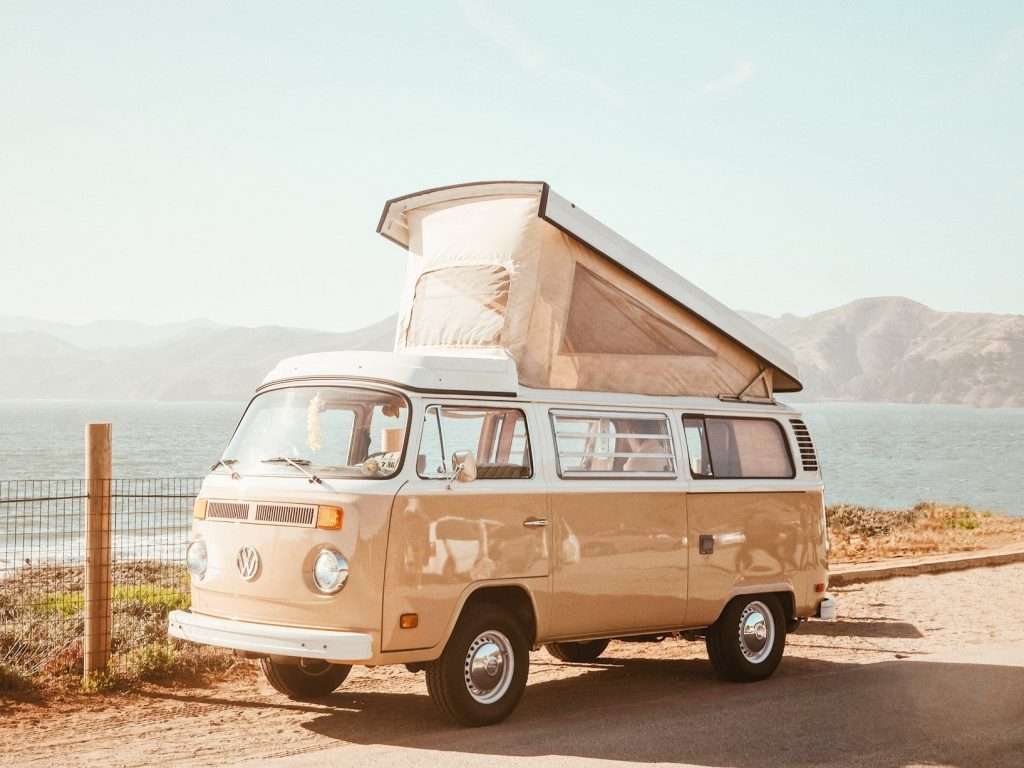 pop up camper parked by the ocean