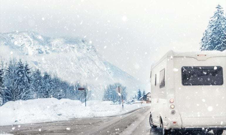camper on a road during the winter