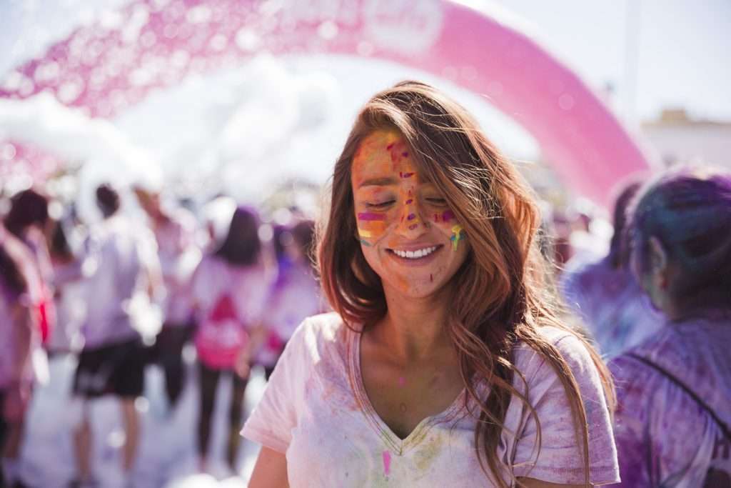 A young woman smiling at the Holi festival of colors